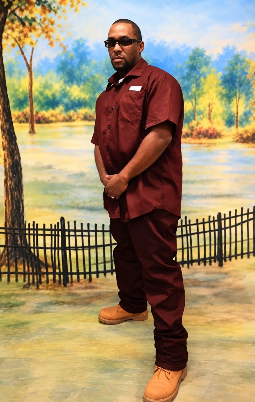Randy D. Petty in sunglasses in front of a painted park scene