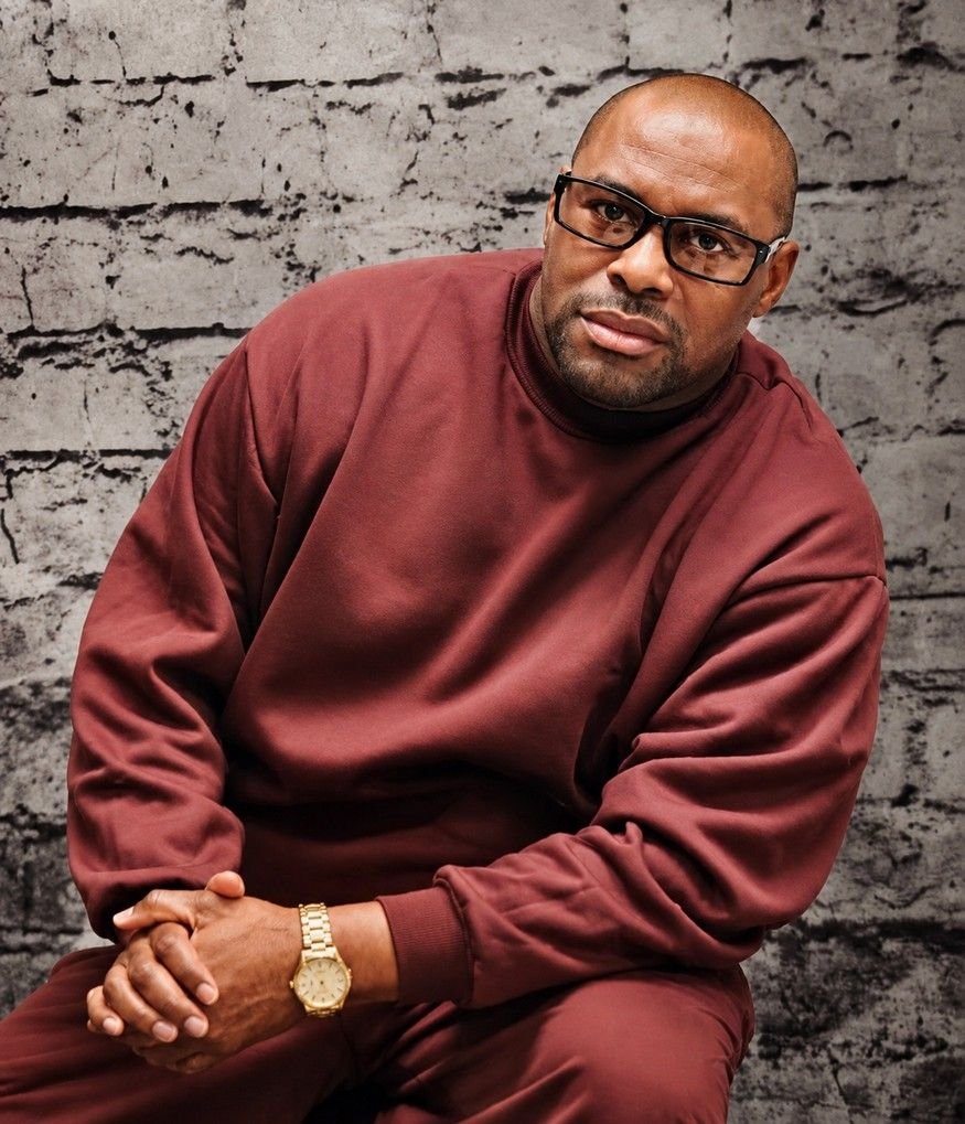 Randy D. Petty seated, wearing glasses and a gold watch