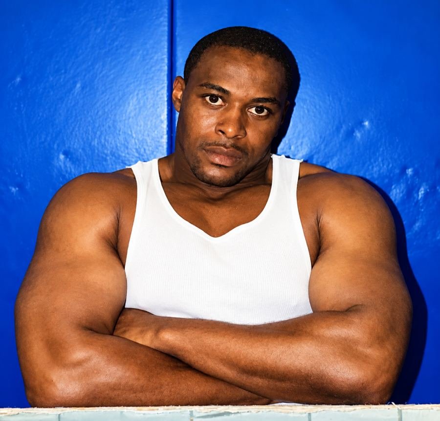 Randy D. Petty, arms crossed, in front of a blue wall